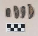 Animal teeth fragments, burned, some perforated, one with copper staining