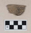 Mammal bone fragment, partially burned