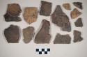 Coarse earthenware body and rim sherds, cord impressed; some sherds crossmended with glue; most sherds crossmend