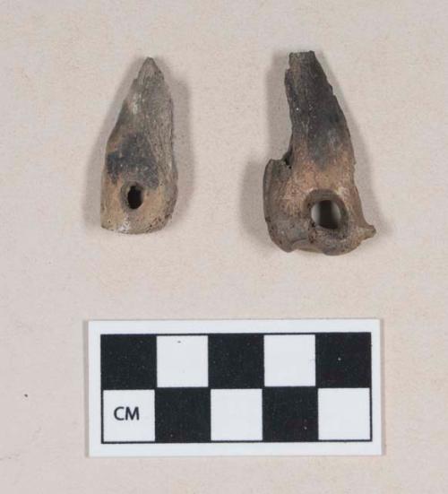 Perforated worked animal bone fragments, one calcined