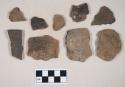 Coarse earthenware body and rim sherds, some cord impressed, some rocker dentate, one punctate