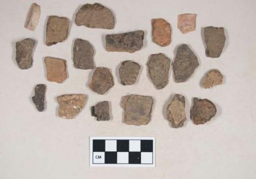 Coarse earthenware body sherds, some undecorated, some cord impressed, some rocker dentate, some incised; chipped stone, flake; chipped stone, prismatic blade; bone fragment