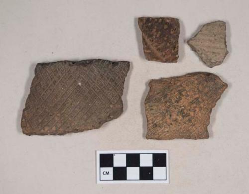 Coarse earthenware body and rim sherds, incised and punctate