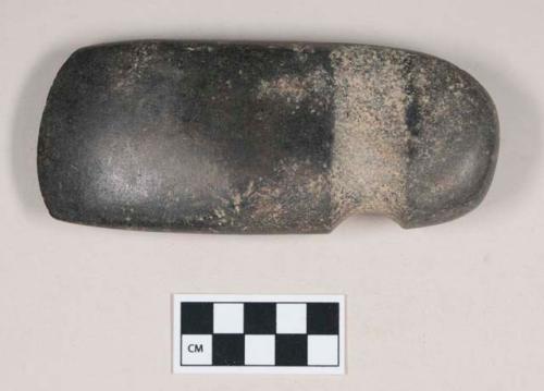 Ground stone axe, pecked three-quarter groove