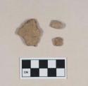 Coarse earthenware body sherd, undecorated; non-cultural stone fragments