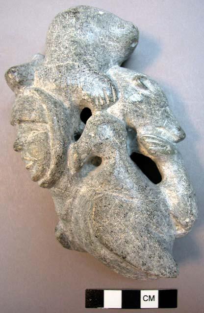 Stone carving of man and animals