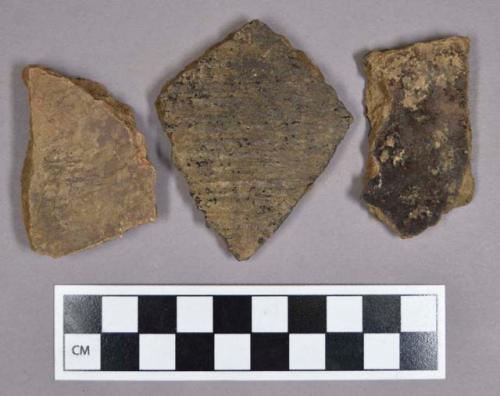 Ceramic, earthenware body sherds, including undecorated, cord-impressed, incised, and punctate; one sherd is mended