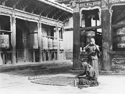 Person sitting on floor, arranging objects