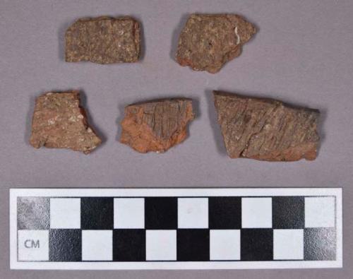 Ceramic, earthenware rim and body sherds, cord-impressed; some mended