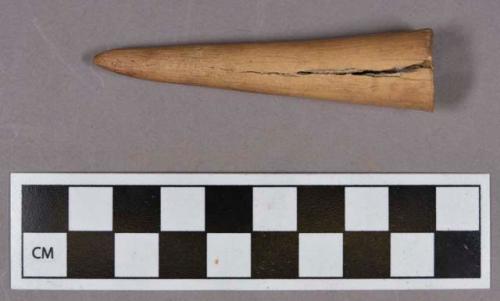 Organic, utilized antler, hollowed conical implement with burnished surface