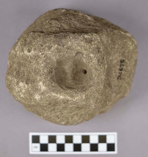 Ground stone, grinding stone, worn base, perforation on top and side