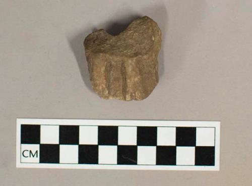 Ground stone effigy figurine, has two legs with paws