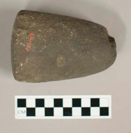 Ground stone pestle, bell shaped, pitted