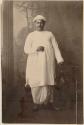 Studio portrait of a man standing and holding an umbrella