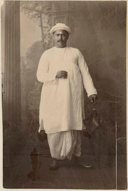 Studio portrait of a man standing and holding an umbrella