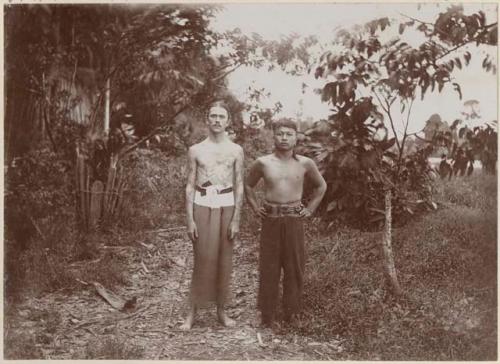 Two men standing in a clearing
