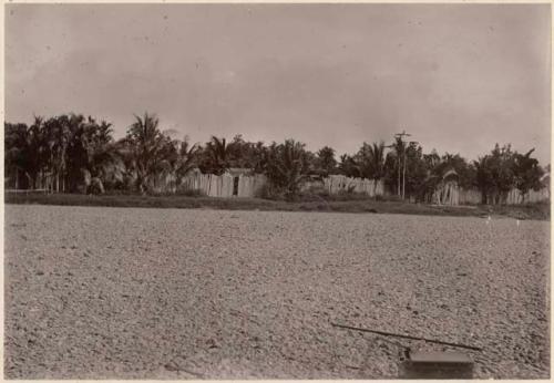 Open gravel area bounded by wooden fence