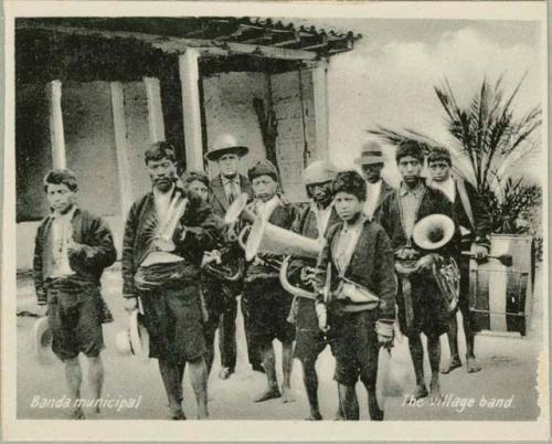 Group photograph of village band with brass instruments and drums