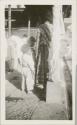 Woman and two children at public washing station, possibly Antigua