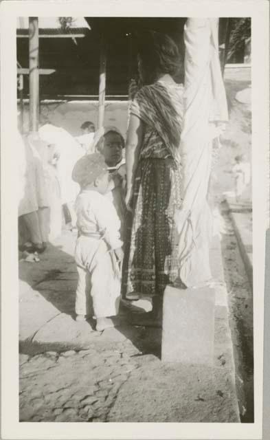 Woman and two children at public washing station, possibly Antigua