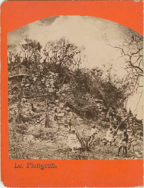 Men and one woman, possibly Alice Dixon Le Plongeon, standing on the Grand Stairway at the Palace of the Priests