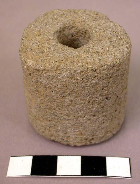 Ground stone roller, perforated through center