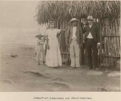 Two men, woman, and child standing for photograph