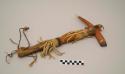 Ax, pointed antler head with chipped stone blade, hide fringe, carved wooden handle, stained red, feathers
