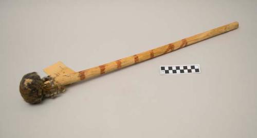 Painted resting stick. Padded head of squirrel skins. Ornamental design.