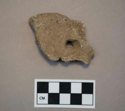 Soapstone disk fragment with hole