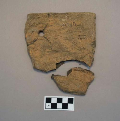 Fiber-tempered plain rim sherd with drilled hole