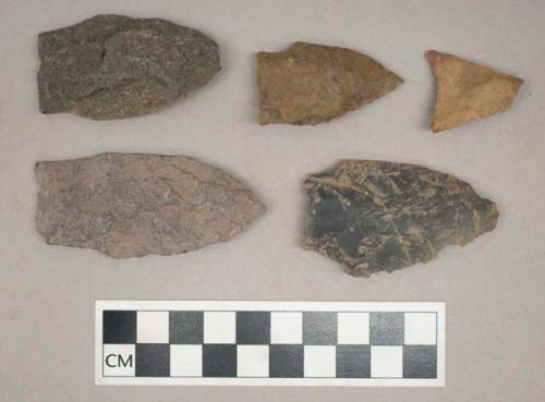 Chipped stone, triangular and straight stemmed bifaces, some are broken