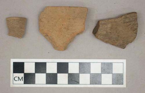 Ceramic, earthenware, punctated pipe bowl fragment and impressed body sherds