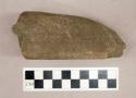 Ground stone, fragment with flat base and tapered edge, possible pick