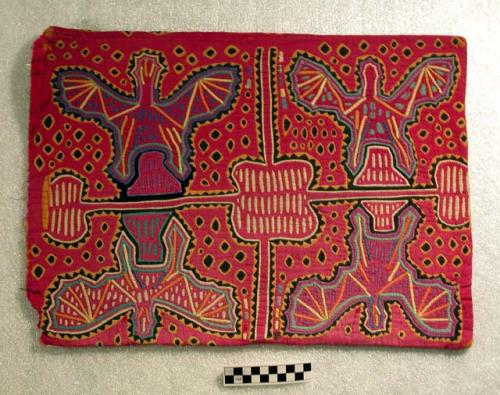 Two matching molas, which have been made into a pillow case.