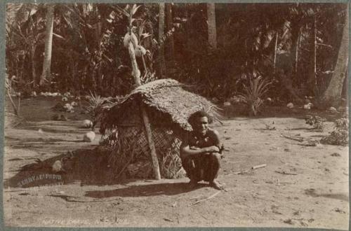 Man sitting in front of grave