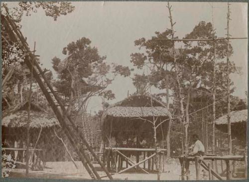 Man sitting, with houses in background