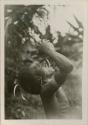 Man drinking from a coconut