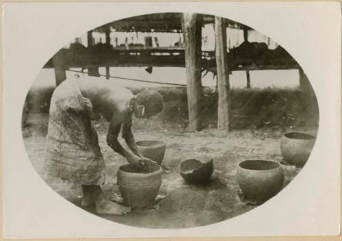 Woman putting the rim on a pot