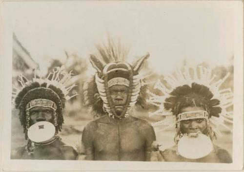 Three men with headdresses