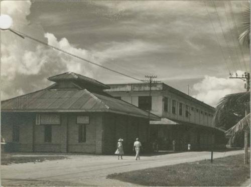 Street scene, building at left with Coca Cola signs