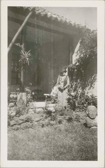 Woman standing on the patio of the Mayan Hotel