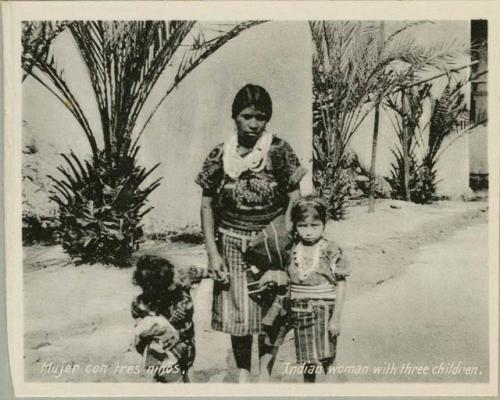 Woman with children (photograph says three, but image shows two)