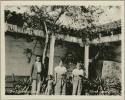 Three generations of a family stand outside posing for photograph