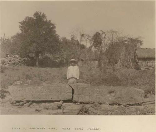 Man standing behind Stela 7, southern side