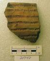 Ceramic rim sherd, grooved and impressed