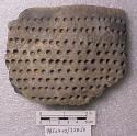 Ceramic rim sherd, circular dentate design