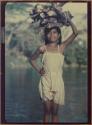 Girl carrying wood on head