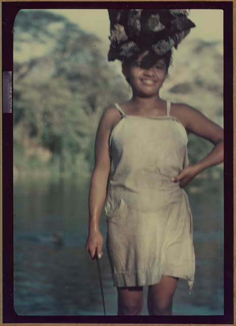 Girl carrying wood on head