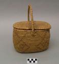 Small oval utility basket, coiled. With lid. Made of bear grass.